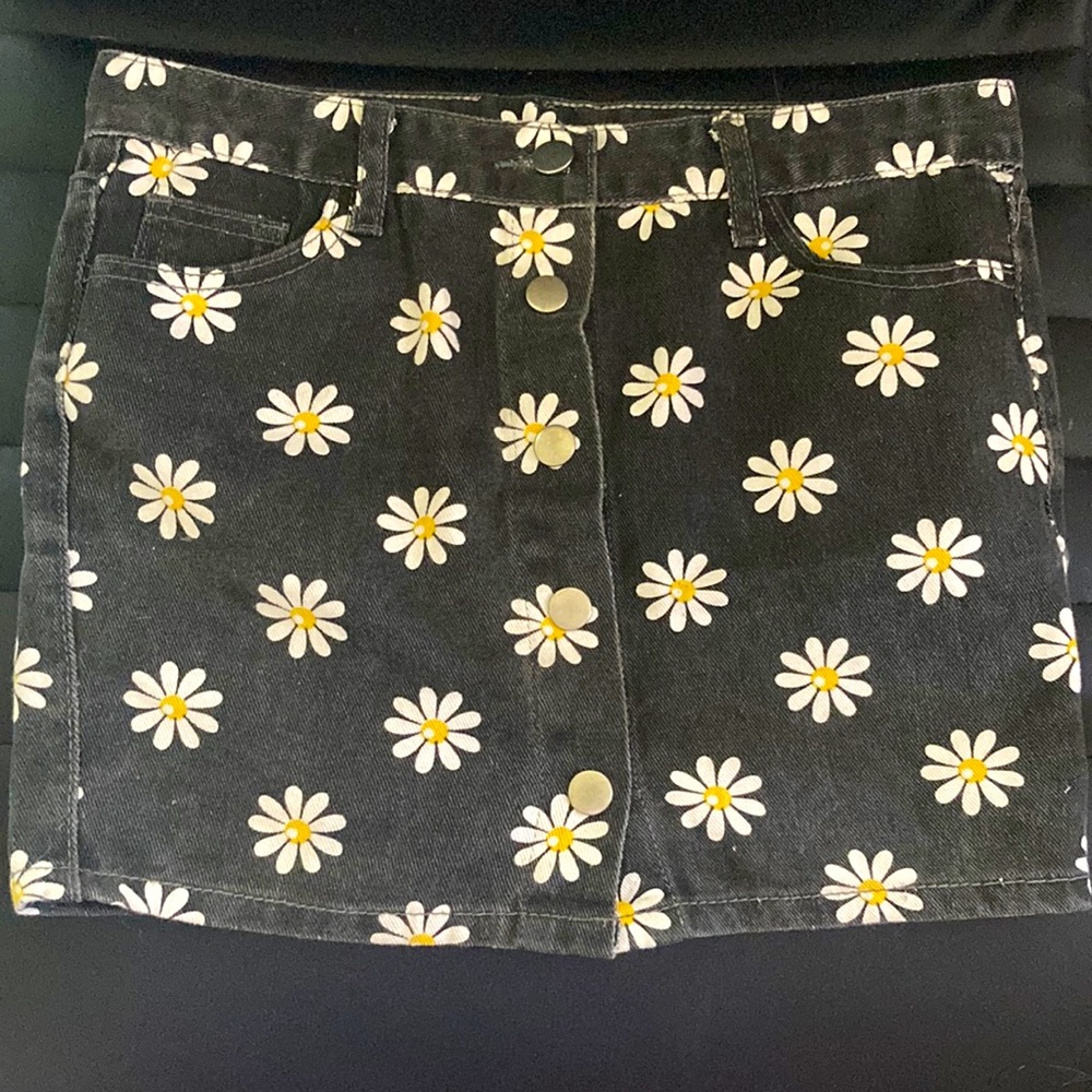 Black denim skirt with white flowers.